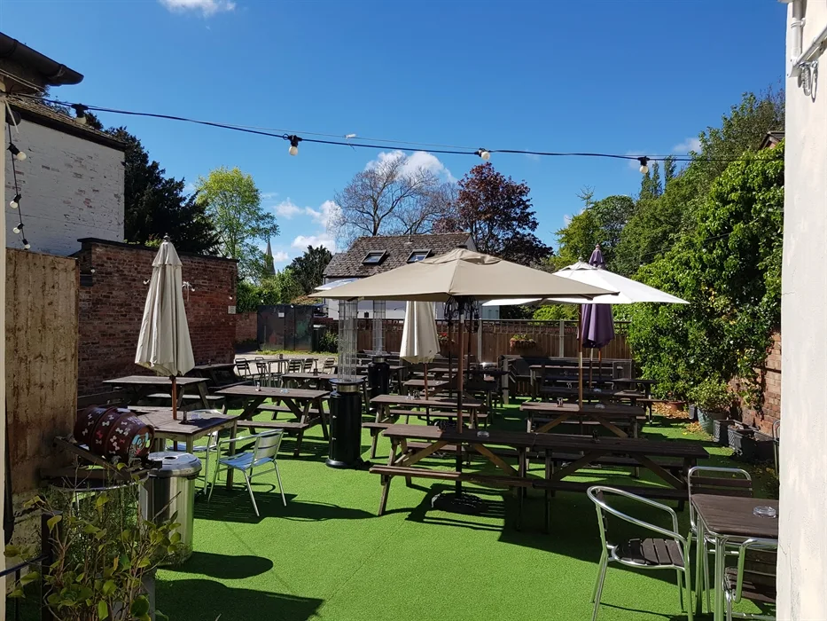 Sunny garden tables and planting behind The Strand in Cheltenham