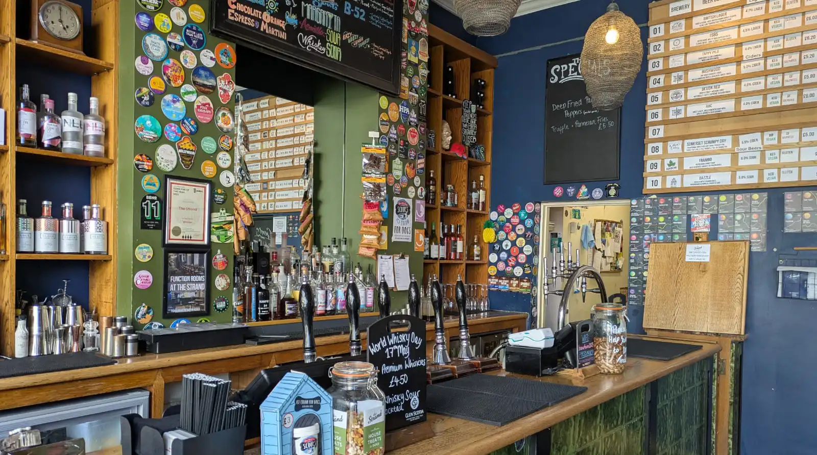 The colourful bar and changing beer board at The Strand